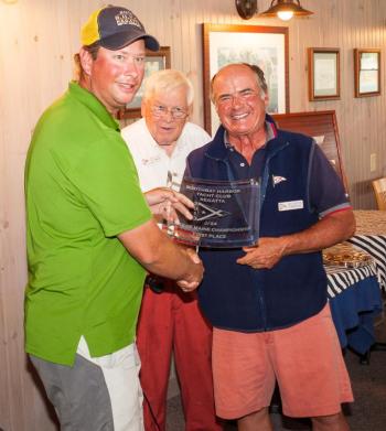 Winner of the Maine State J-24 Championship held last weekend at the Boothbay Harbor Yacht Club  is Carter White, left, holding the trophy and being congratulated by PC Andy Holmes, regatta Chair, and Commodore Neil Newton. Courtesy of Donald Snyder