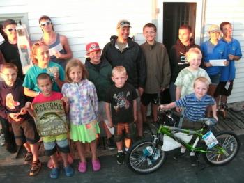 Winners and door prize recipients in the 9th Annual Boothbay Region Fish & Game Association Saltwater Fishing Tournament pose for a group photo behind young Danny Gray, who won the top Junior Division door prize of a brand-new stunt bicycle. Photo by Barry Gibson