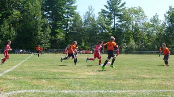 Midcoast United U-13 player Sullivan Fink works the ball down the field in last Sunday's game at Winslow. Courtesy of Marcy Tilas