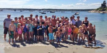 Competitors in the Arthur Hale Veasey Memorial Regatta gather on the Squirrel Island beach following the awards ceremony. Courtesy of Larry Sirois