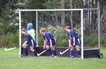 Goalie Tori Morin and Elise Mead, Elizabeth Ham and Gabby Staples prepare for a penalty corner. Courtesy of Michelle Bouchard