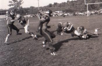 Week 1 Challenge winner Kevin Burnham is dropped to the Sherman Field turf by a Hyde player, circa 1973.