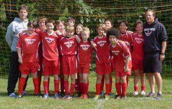 The 2013 Midcoast U13 team. Pictured from left are, front row: Jack Buthy, Sullivan Fink, Avery Stewart, Will Shaffer, Markus Russell, Bayly Gaughan; back row: Coach Lester Spear, Isaac Craig, Ben Jacobs, Timmy Chappelle, Ella Spear, Lucas Kelsey, Ethan Carmolli, Simon Spear, Assistant Coach J.H. Russell. Not present that day was Stevie Reny. Courtesy of Marcy Tilas