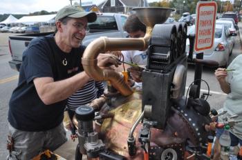 Jacques Vesery, left, Jonah Vesery, center and Minda Gold, right, all work Friday, Oct. 11 on “Steampumpkin” on Main Street in Damariscotta. With Pumpkinfest this weekend the Twin Villages have filled with pumpkins and tourists. BEN BULKELEY/Boothbay Register