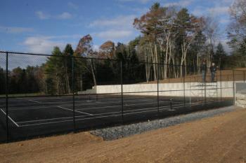 The fence is up, temporary lines are down but the new tennis courts on the Boothbay Harbor school campus won’t be ready to use until spring. KEVIN BURNHAM/Boothbay Register