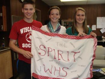 This spirit flag made under a previous Wiscasset High School student council will likely make an appearance at a January 31 rally the school is planning as part of a competition put on by Portland television station WGME. Pictured from left are current student council president Logan Grover, vice president Briana Goud and secretary Sarah Hanley. SUSAN JOHNS/Wiscasset Newspaper