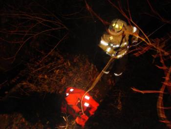 Rescuers head down a banking to where a vehicle was reported in the water under a Dock Road, Alna, bridge. SUSAN JOHNS/Wiscasset Newspaper