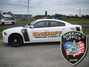 A Waldo County Sheriff cruiser and patch. 