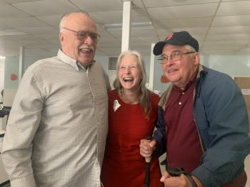 2025 Maine Teacher of the Year Becky Hallowell, who teaches fourth grade at Wiscasset Elementary School, is flanked by her uncles Michael “Jim” Bilinsky, left, and Daniel Fortin at a reception after Hallowell learned she’d won the statewide honor. SUSAN JOHNS/Wiscasset Newspaper 