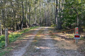 Peter Mullin's property in Boothbay with a chain across the driveway and a sign that reads "not for sale."