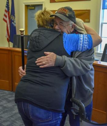 Edgar Lewis hugs family.