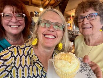 From left, Christine Buckley, Patrisha McLean, and Mary Lou Smith enjoying a yellow taste treat at the 2024 “Into the Light!” Foodie Festival that raised $28K for Finding Our Voices. 