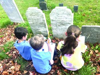 Wyatt Underwood, William Marshall, Paizley Marr explore a gravestone. Emma Rossignol photo