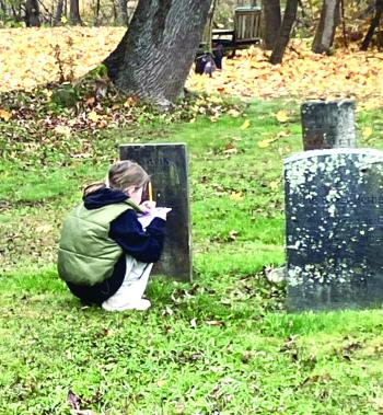 Kali Gallloway scooches as she takes notes at a gravestone. Becky Hallowell photo 