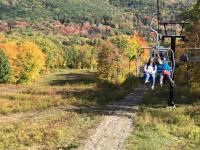 People riding the Snow Bowl chairlift.