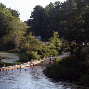 Swimmers and sunbathers enjoy hot, humid days along Nequasset Brook in Woolwich. Selectmen hope to make improvements to the town park and mitigate any conflicts between boaters and swimmers there. JOHN MAGUIRE/Wiscasset Newspaper