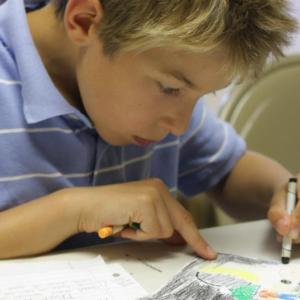 Ben O'Brien of Harpswell finishes illustrations for his creative story at the Seeds of Knowledge “Catch the Writing Wave” camp in Wiscasset. Courtesy of Seeds of Knowledge