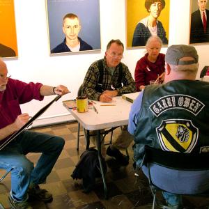 Dwayne Keller, foreground, a Vietnam War veteran, sits for portraits by artists, from left, Robert Shetterly, Kenny Cole and Charlene Decker during an Armistice/Veterans Day draw-a-thon.