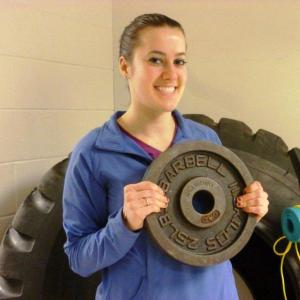 Melissa Hake, the Y’s Wellness Coordinator, holds the 25-pound weigh female contestants will be using during the “Legs of Steel” challenge. KATRINA CLARK/Boothbay Register