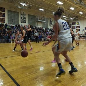 Alex Clarke fires a pass to Hannah Morley under the basket during Friday's game against Hall-Dale. 