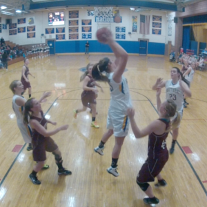 Alex Clarke grabs a rebound over Monmouth during the home opener, December 11. RYAN LEIGHTON/Boothbay Register