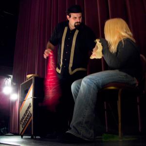 Conjuring Carroll performs a magic trick on stage at the Colonial Theatre with help from Lexi Richard. (Photo by Ethan Andrews)