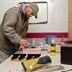 Joe Mathiau of Lincolnville pours plastic resin for hotel door lock covers at the Morrill headquarters of Sure Tech Industries. Security upgrades in the hospitality industry, and more recently the Sandy Hook Elementary School shootings, have given the lock business got an unexpected boost. (Photo by Ethan Andrews)