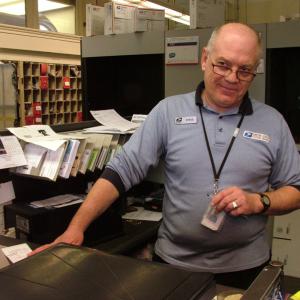 Steve Clark, a familiar face behind the counter at the Belfast Post Office, is retiring this week after 28 years at the branch. (Photo by Ethan Andrews)