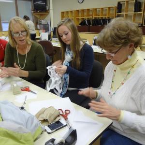 Students and staff get together in December to make snowflakes to send to Sandy Hook Elementary School. Left to right are Ryan Hanley, Mary Ellen Bell, Becca Erskine and Margaret Scally. Courtesy of Wiscasset High School