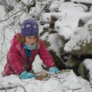 Audrey Hufnagel a first grader at the Juniper Hill School takes part in an outdoor lesson on winter animals and tracking. The Alna-based school will host an open house on March 14, at 3 p.m. Courtesy of Juniper Hill School