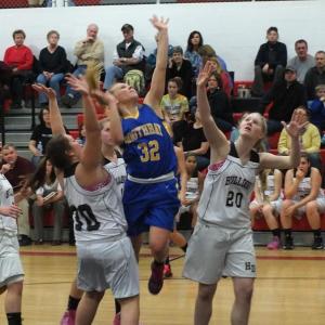 Sophomore Morgan Crocker slices between two Hall-Dale defenders to get off a shot during Tuesday's game in Farmingdale. Crocker led all scorers with 12 points. RYAN LEIGHTON/Boothbay Register