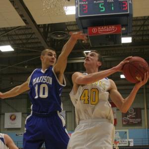 John Hepburn's leaping ability allows him to get off shots, including this shot over Madison's Dylan Price during last week's tournament game. KEVIN BURNHAM/Boothbay Register