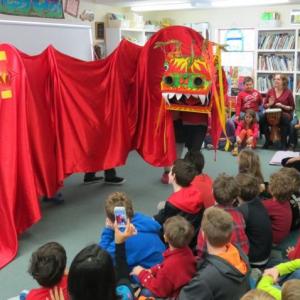 Students enjoy a dragon dance. Below: Fifth Graders Joe Guenther and Nicco Bartone of Bath and sixth grader Ella Dempsey Blair of Phippsburg enjoy Chinese food as part of the school’s Chinese New Year celebration. Courtesy of Center for Teaching and Learning