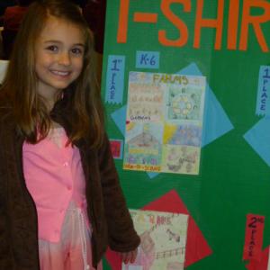 Mara Abbott, daughter of Jason and Alexa Abbott of Westport Island, is all smiles as she is recognized for creating the best T-shirt design in the Focus on Agriculture in Rural Maine Schools’ contest. Courtesy of Alexa Abbott