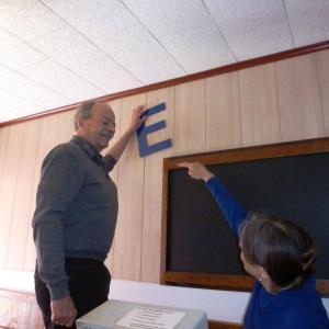 Peter and Nancy Gilchrist argue playfully about what angle the letters spelling Ebb Tide should hang on the wall. KATRINA CLARK/Boothbay Register