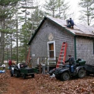 Spring 2005: Almost 50 years to the day from when construction first commenced, club volunteers gather to install a much needed new roof on their club house. Courtesy of Lucy Schmidt