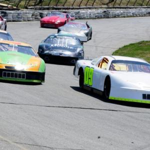 Darrin Ripley, of Appleton, driving the #9 car, is the first to cross the finish line in the Late Model Sportsman feature at Wiscasset Speedway on Saturday, April 27. courtesy of Peter Taylor, Wiscasset Speedway