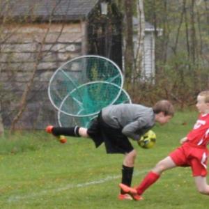 Midcoast striker Will Shafer charges after the ball during the second half of play at Clifford Playground. Shaffer scored on a breakaway in the opening seconds of the match. SUE MELLO/Boothbay Register