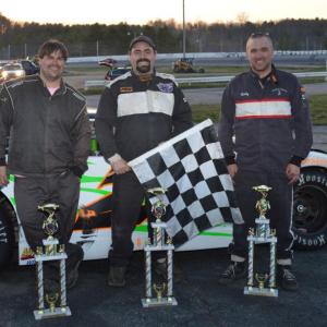 Josh Bailey of Wiscasset, center, holding the checkered flag, celebrates his first career win in the Super Stock race on May 4 at the Wiscasset Speedway. Adam Chadbourn of Woolwich, left, took third and Bobby Mesimer of Wiscasset, right, took second place. Courtesy of Peter Taylor, Wiscasset Raceway