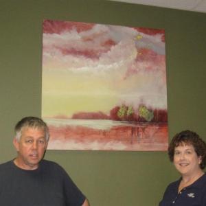 Allen Bunker stands in front of one of his paintings and beside First Federal branch manager Jean Huber. Courtesy of Sandy Terry