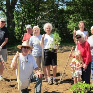 Scott Rittall, front, with help from the volunteers behind him, completed the planting of the community garden at Rittall Farm on Route 27 in Boothbay on June 15. Courtesy of Sarah Foulger