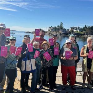 A group of people show of their copies of Love & Lobsters