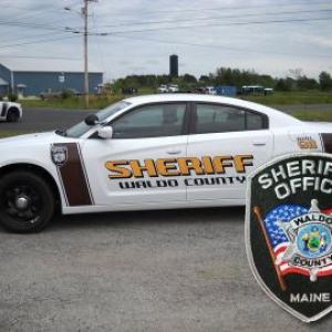 A Waldo County Sheriff cruiser and patch. 