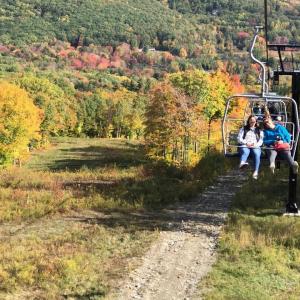 People riding the Snow Bowl chairlift.