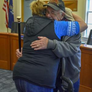 Edgar Lewis hugs family.