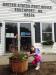 8-year-old Sofia Stenberg admires the flowers that she and Jen Auber planted in the new whiskey barrels in front of the Southport post office last week. The Southport Island Association donated the flowers and barrels. Courtesy of Jen Auber 