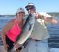 Kate White of Luray, Va. and Squirrel Island caught and released her first striped bass, a 32-incher, with Capt. Barry Gibson on July 4. Local charter boat skippers are reporting good catches of stripers. Courtesy of Bill White