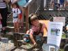 Tucker Davenport, 6, son of Bill and Heather Davenport of Wiscasset, enjoys his time in the stocks, where pirates put him and many other Fourth of July celebrants to raise "bail" money for Feed Our Scholars. SUSAN JOHNS/Wiscasset Newspaper