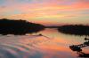 A lone boater chooses an especially special summer sunset to cruise through the “Gut.” Townsend Gut is a highly trafficked water route separating Boothbay Harbor and Southport. Courtesy of Daniel Fayen 