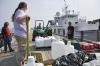 Deb Lomas, left, and Dave Clifford, right, help unload pallets August 19 at Wotton's Wharf. Lomas said some of the samples came from the biologically-rich Sargasso Sea. BEN BULKELEY/Boothbay Register